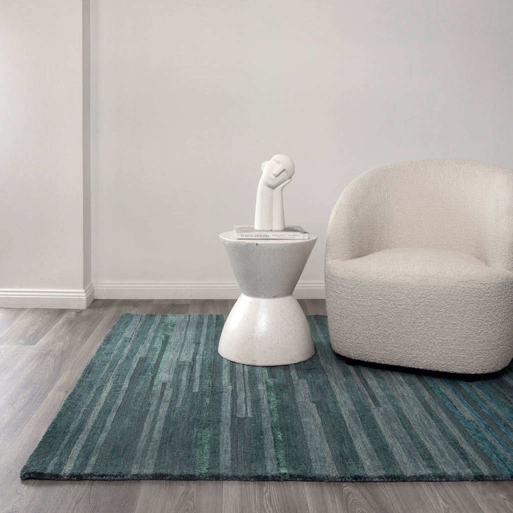 Les Nomades Linear Teal Wool Rug styled with furniture
