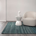 Les Nomades Linear Teal Wool Rug styled with furniture