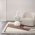 Les Nomades Minimal Beige Wool Rug styled with furniture