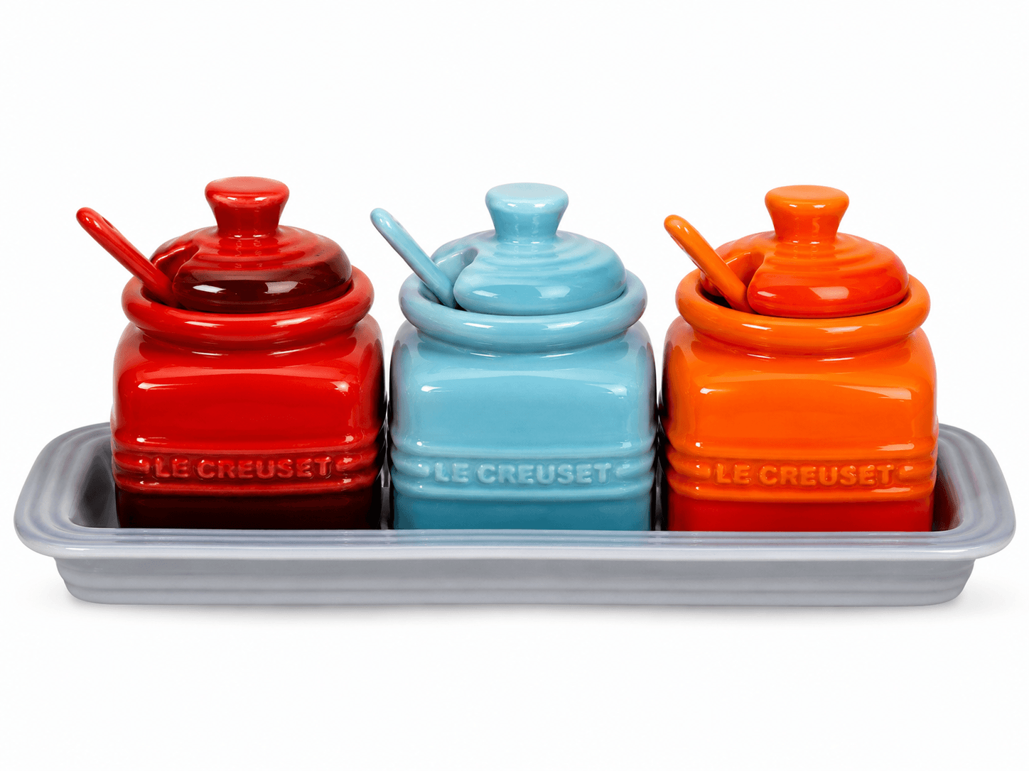Le Creuset Ceramic Condiment Pot Set with Tray featuring red, blue, and orange pots for spices and seasonings.