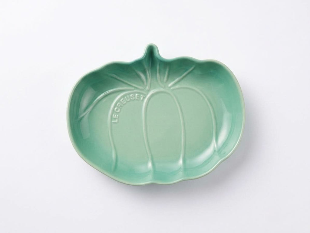 Le Creuset pumpkin shaped dish in green stoneware, perfect for serving autumn dishes and festive treats.