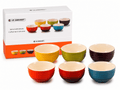 Le Creuset mini stoneware bowls set in vibrant colors, displayed with packaging, ideal for snacks and desserts.