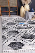 Mansour Diamond Black & White Geometric Rug - 5BWHI styled with furniture