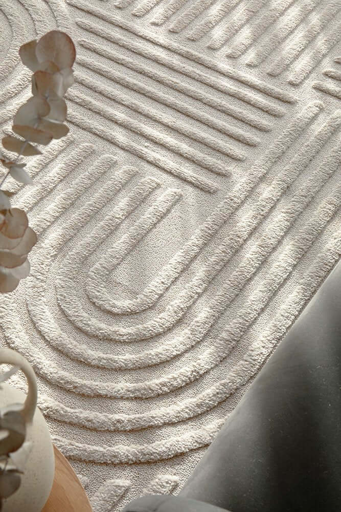 Modern textured area rug with a geometric pattern in cream tones, highlighting soft texture and comfort.
