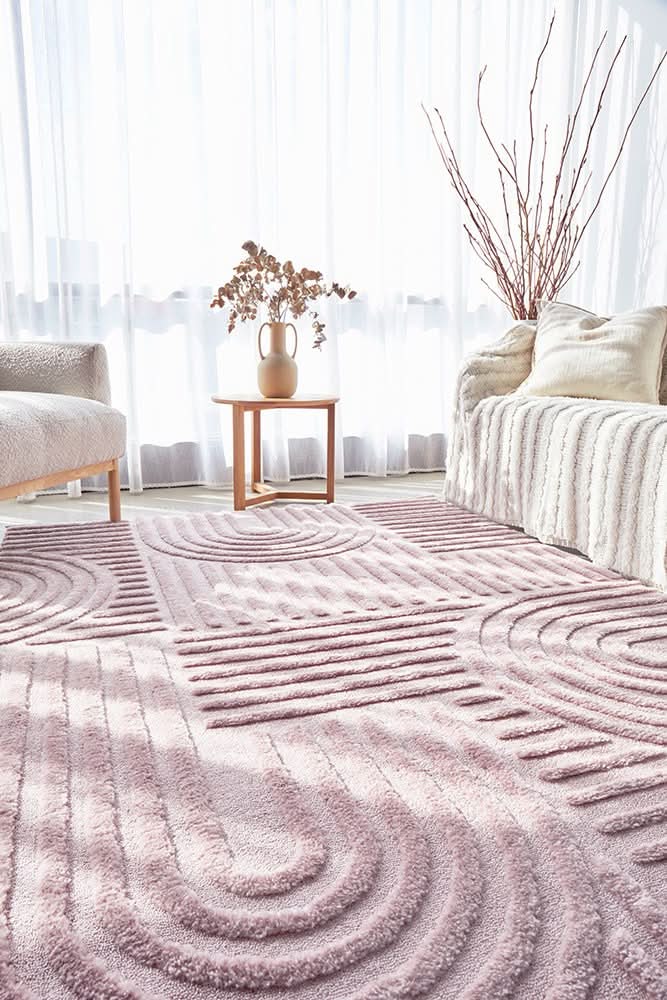 modern pink textured rug in a bright living room, featuring geometric patterns and plush texture for comfort.