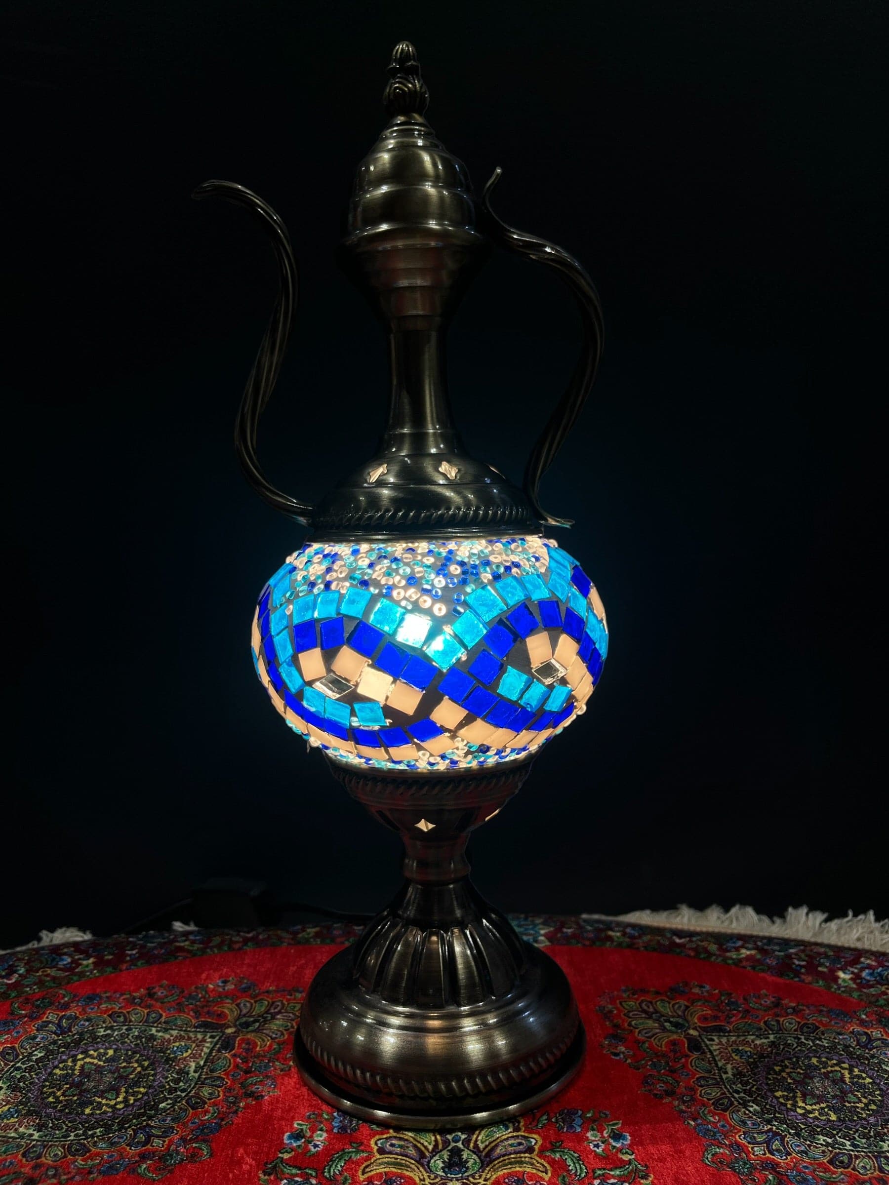 Mosaic Genie Lamp Blue Infinity-Elevate your decor with the enchanting charm of our Turkish Mosaic Genie Lamp. Handcrafted by skilled artisans, this exquisite lamp captures the spirit of the mystical East. Its intricate mosaic glass design creates a mesme