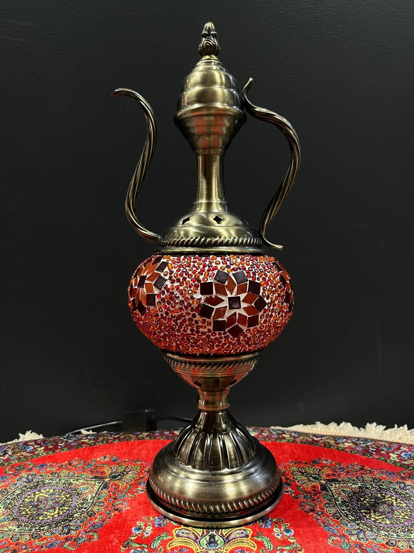 Mosaic Genie Lamp Orange Flower-Elevate your decor with the enchanting charm of our Turkish Mosaic Genie Lamp. Handcrafted by skilled artisans, this exquisite lamp captures the spirit of the mystical East. Its intricate mosaic glass design creates a mesme