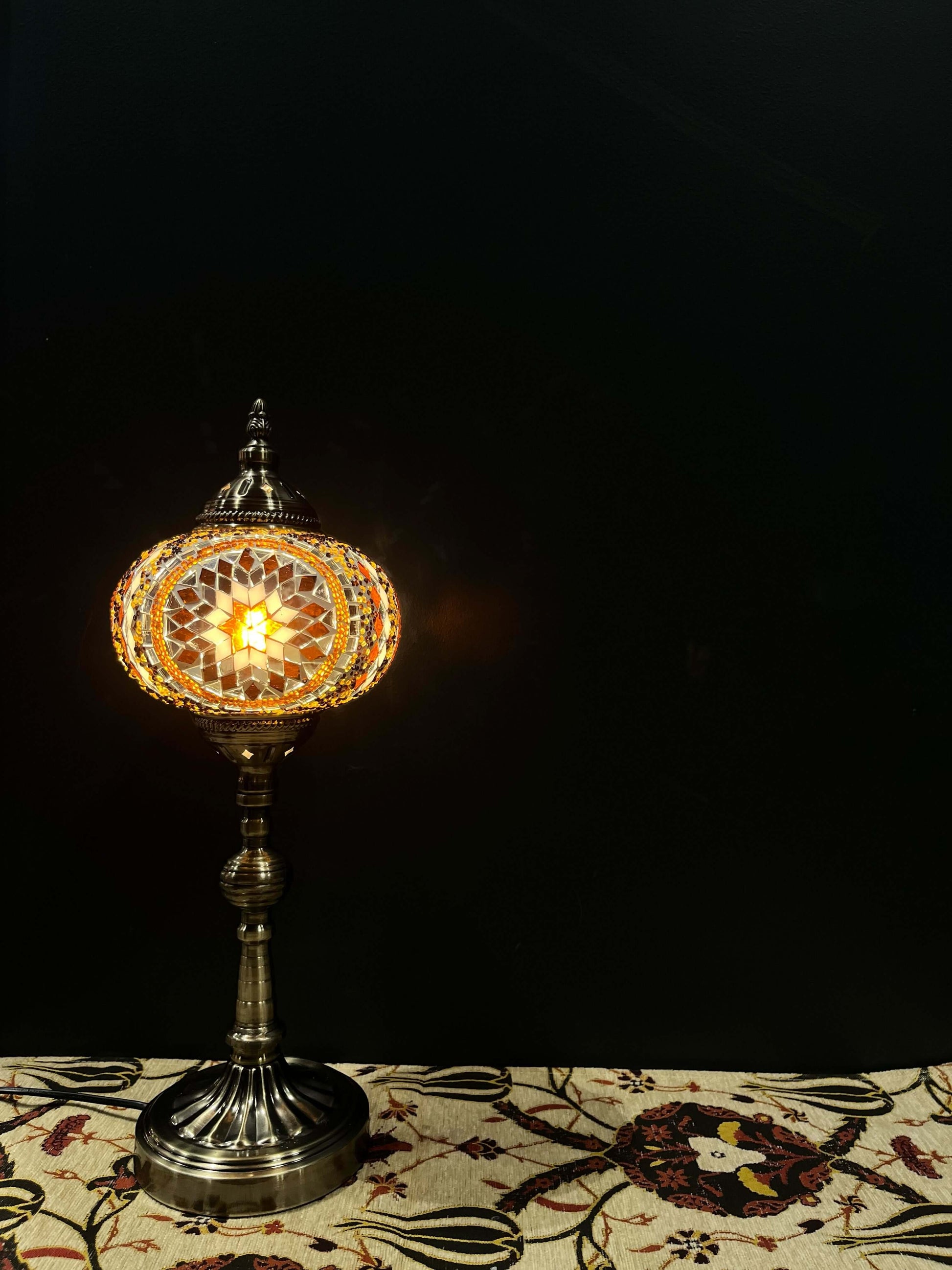 Mosaic Lamp Long Stand 17cm Glass Brown-Brighten your space with our handmade Mosaic Lamp. This vibrant table lamp features a multicolored mosaic pattern that adds elegance and warmth to any room. The intricate mosaic lampshade, crafted by skilled artisan
