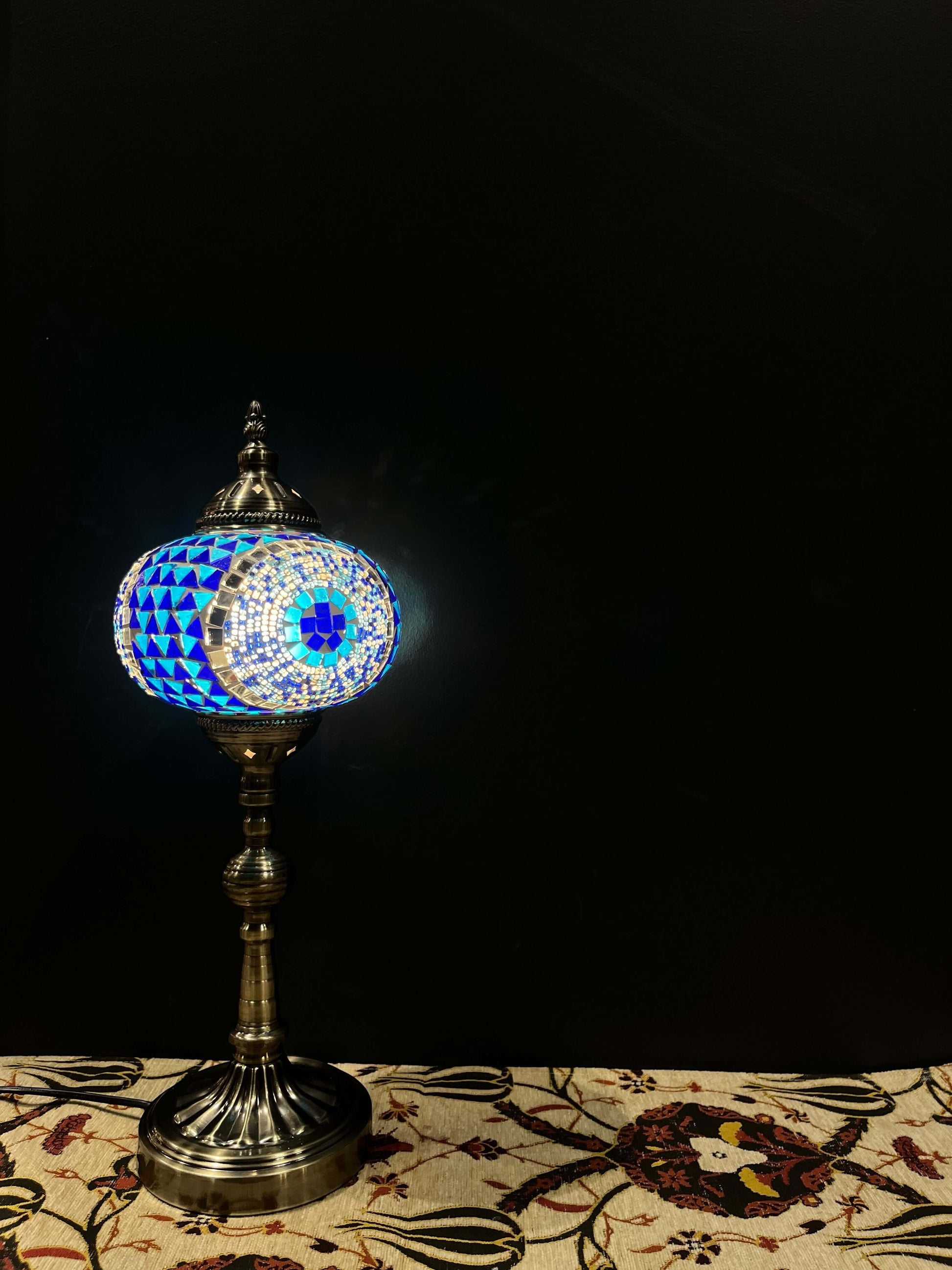 Mosaic Lamp Long Stand 17cm Glass Evil Eye-Brighten your space with our handmade Mosaic Lamp. This vibrant table lamp features a multicolored mosaic pattern that adds elegance and warmth to any room. The intricate mosaic lampshade, crafted by skilled arti