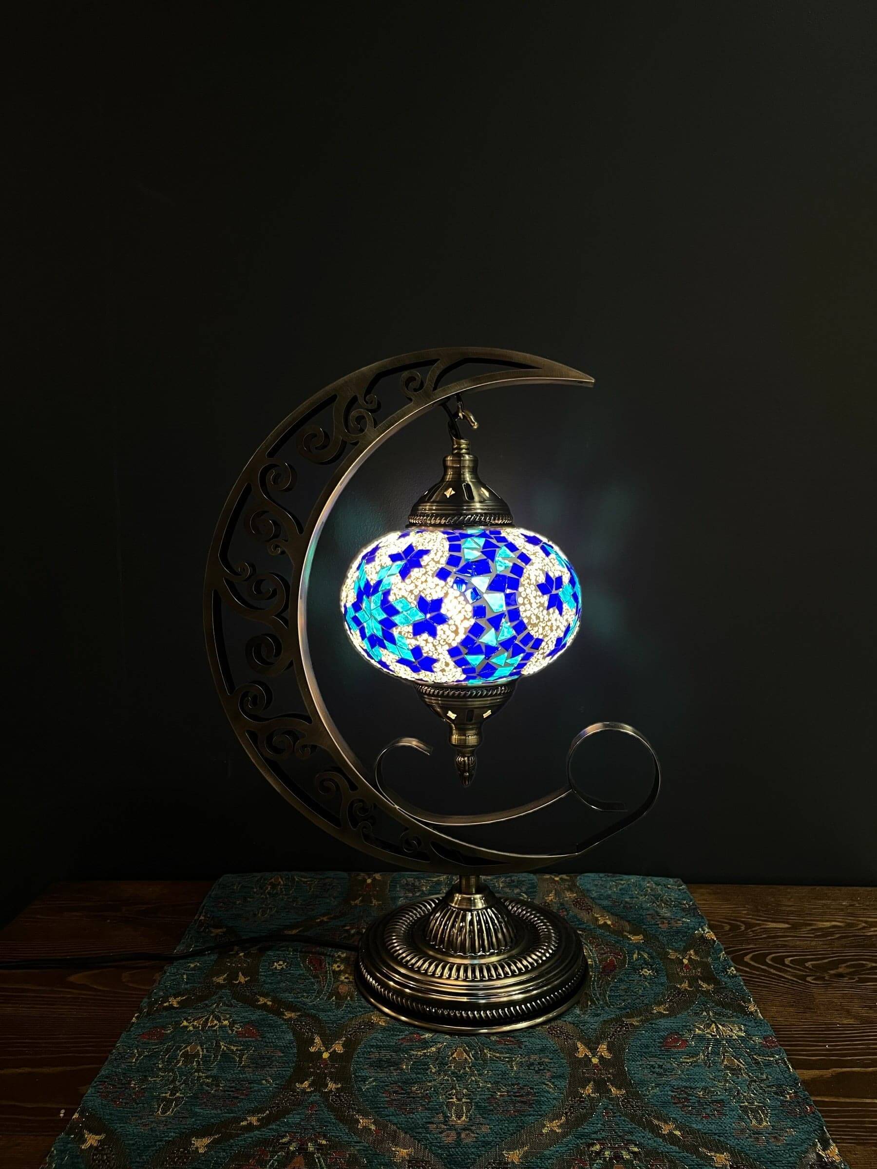 Mosaic Moon Lamp (Turkish Lamps) Blue-Mosaic Moon Lamp, a fusion of Turkish artistry and celestial charm. Handcrafted to perfection, it captures the beauty of Turkish mosaic lamps. Add a touch of lunar elegance to any room, casting a soothing, warm glow.