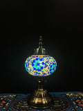 Mosaic Table Lamp with blue flower design illuminating a soft glow, adding charm and elegance to any space.