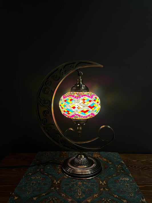 Elevate your space with our Mosaic Moon Lamp, a fusion of Turkish artistry and celestial charm. Handcrafted to perfection, it captures the beauty of Turkish mosaic lamps. Add a touch of lunar elegance to any room, casting a soothing, warm glow. Experience