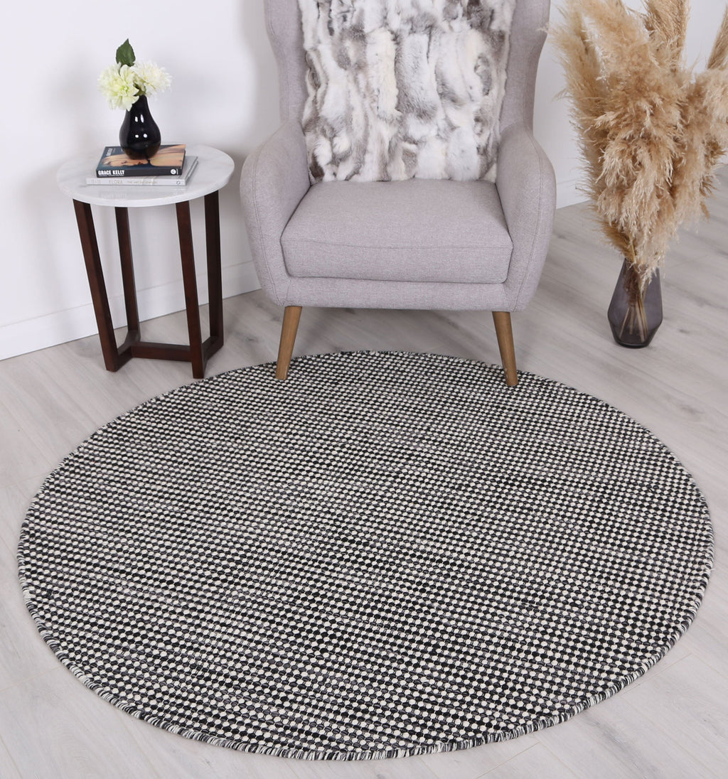 Nordic Charcoal Reversible Wool Round Rug styled with furniture