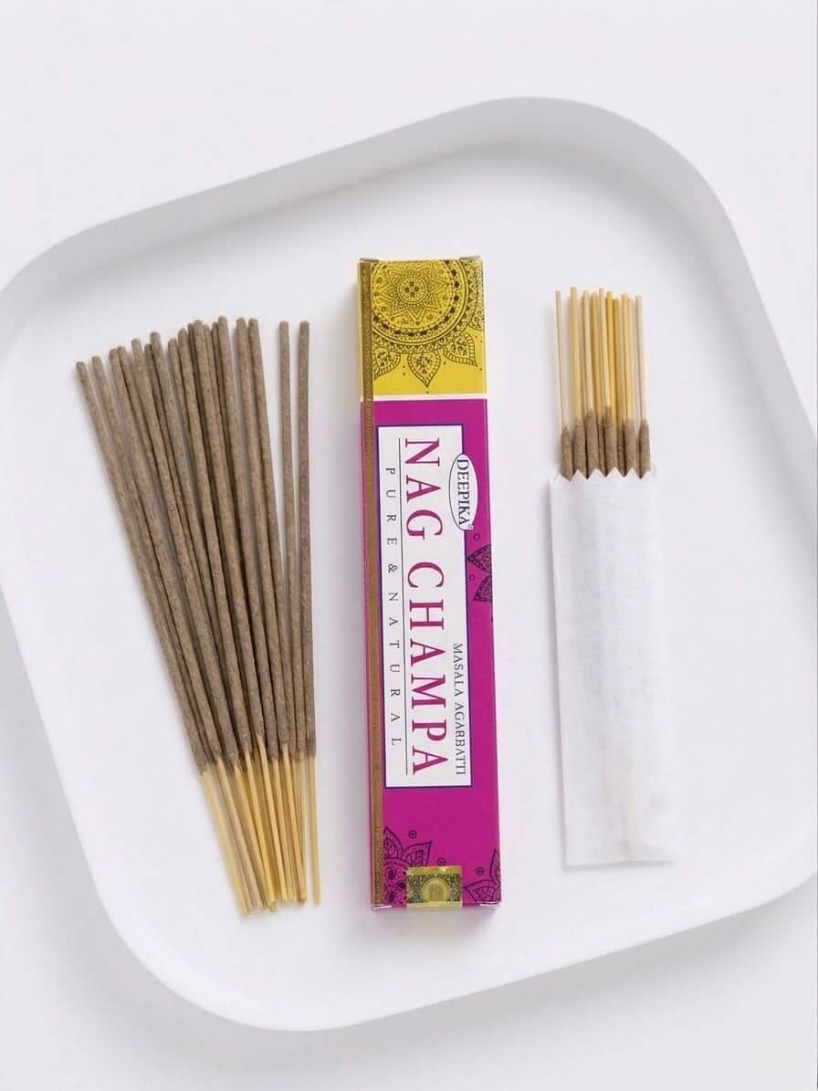 Nag Champa Incense Sticks pack with incense sticks on a plate, showcasing its rich aroma and quality.