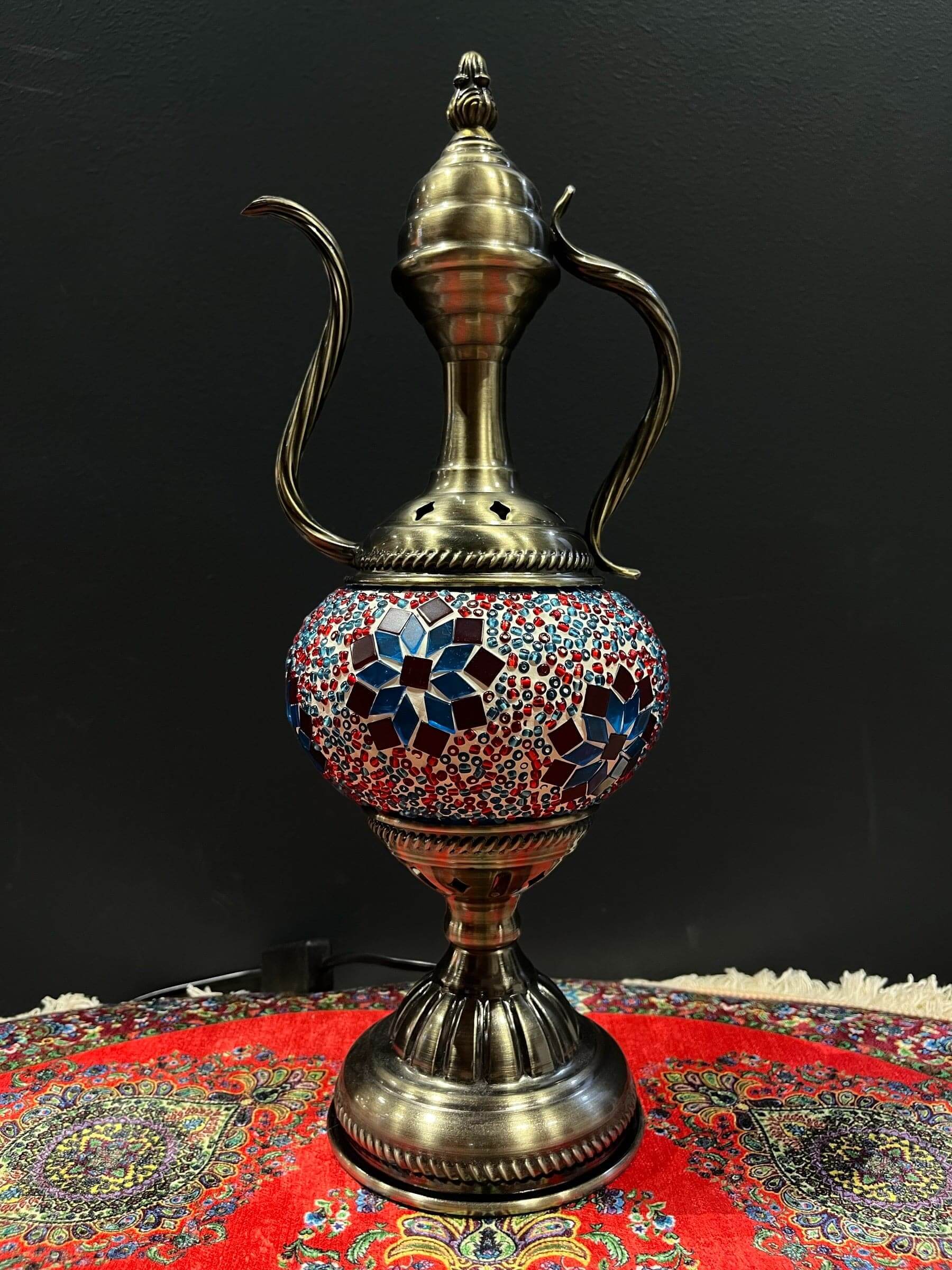 Elevate your decor with the enchanting charm of our Turkish Mosaic Genie Lamp. Handcrafted by skilled artisans, this exquisite lamp captures the spirit of the mystical East. Its intricate mosaic glass design creates a mesmerizing play of light and color,