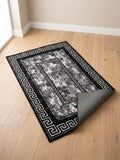 Premium Greek Key Prayer Mat in black, grey, and white design, elegantly placed on a wooden floor.