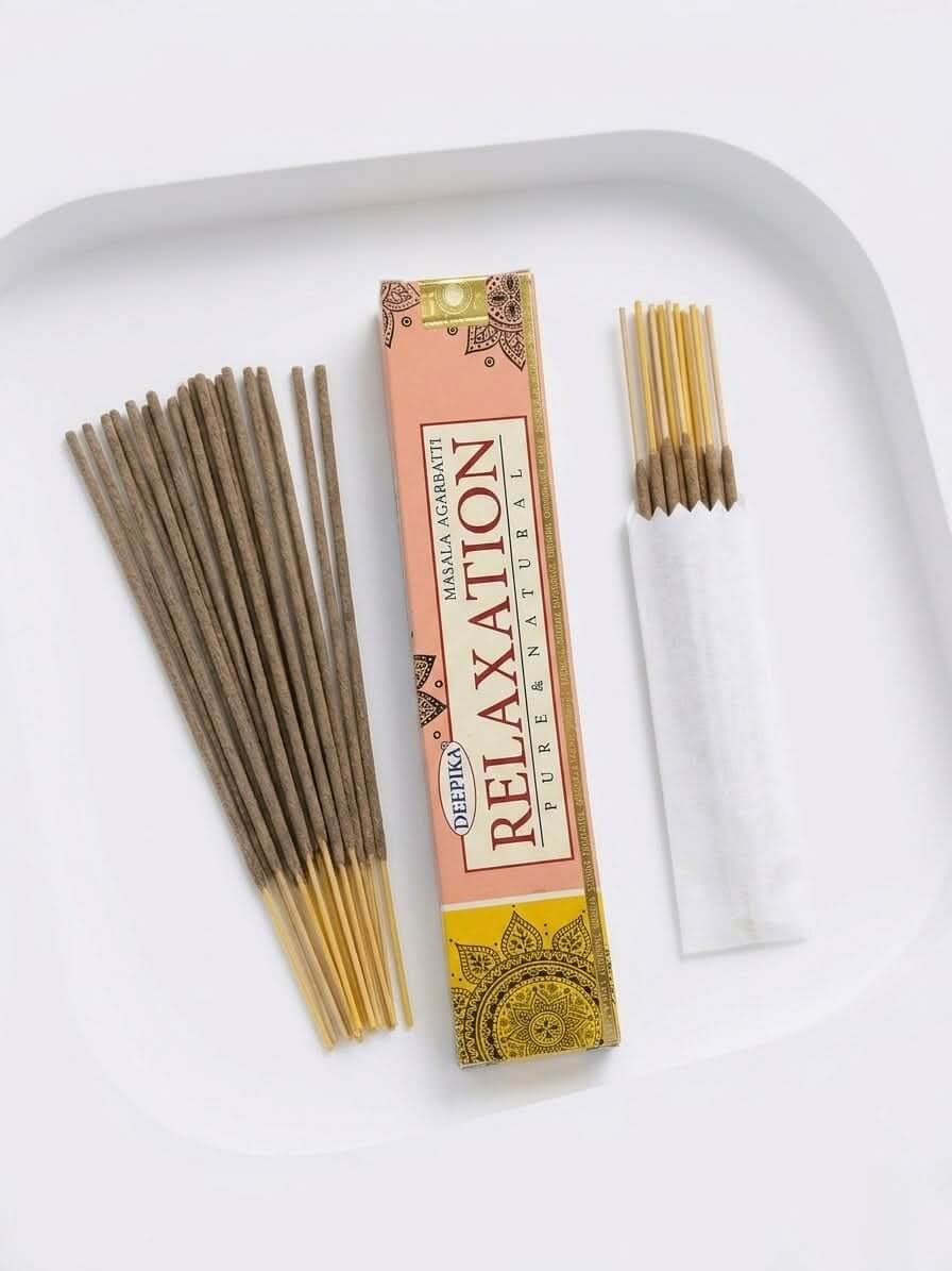 Relaxation Incense Sticks packaging with incense sticks arranged beside it on a white plate.
