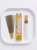 Sandalwood Incense Sticks in a tray, showcasing the box and burning options for a calming atmosphere.