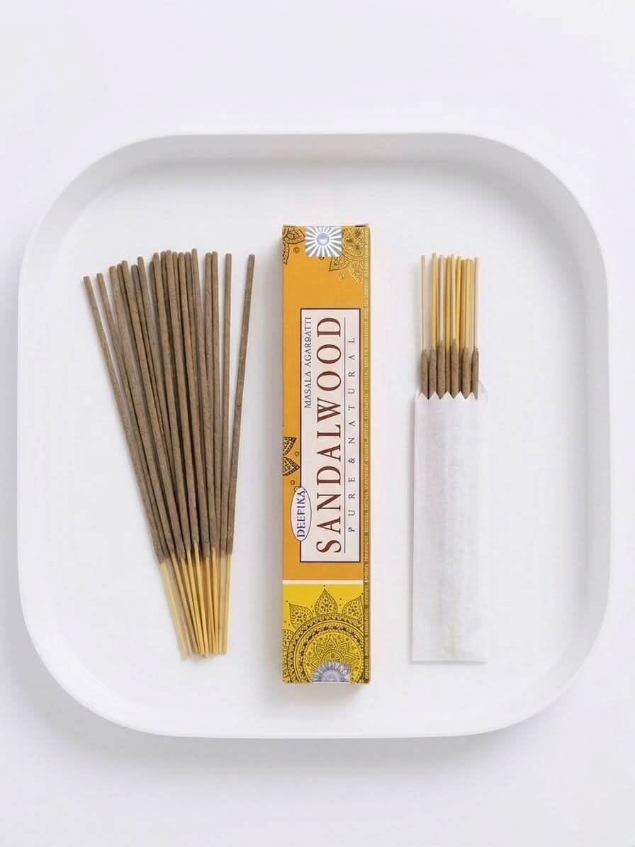 Sandalwood Incense Sticks in a tray, showcasing the box and burning options for a calming atmosphere.