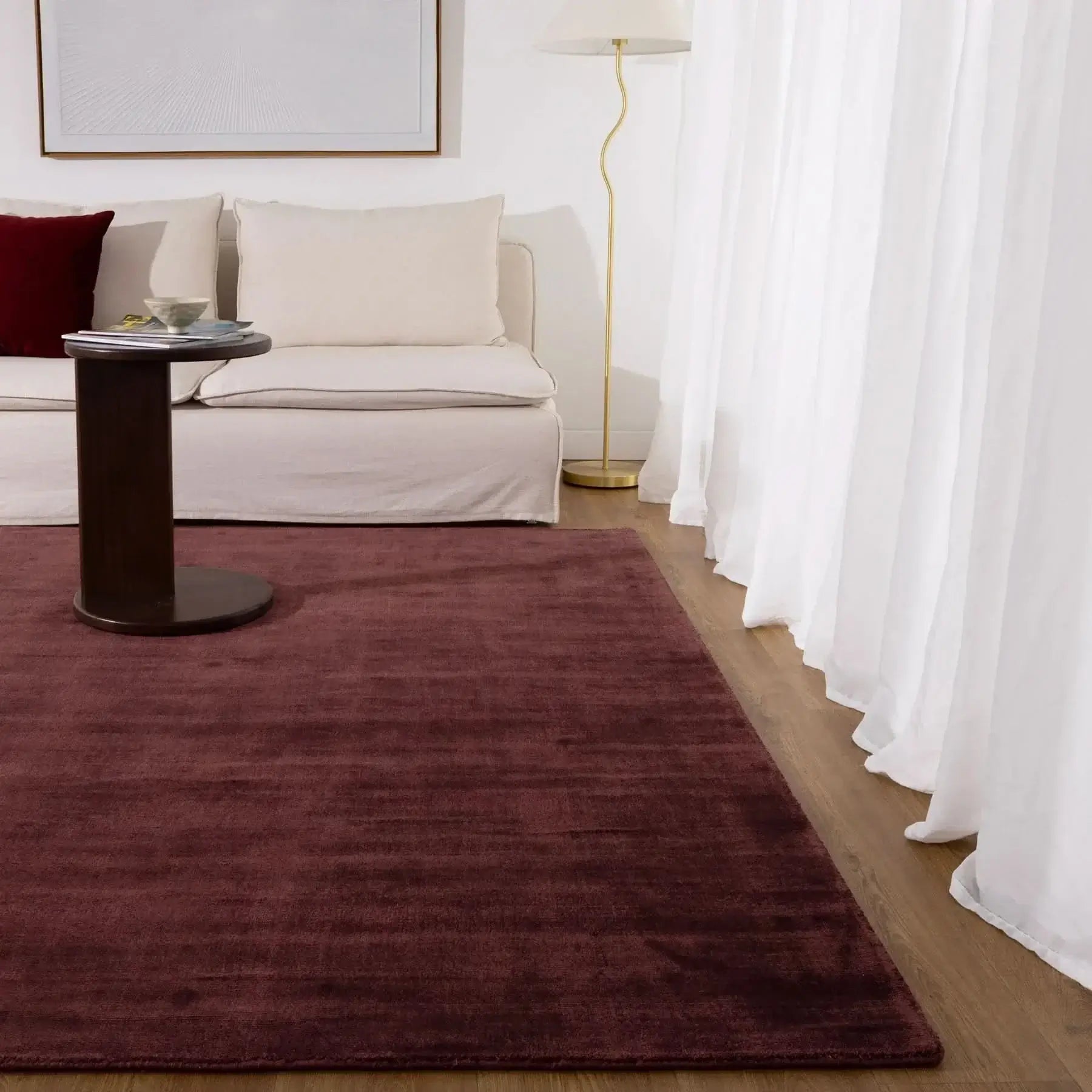 Silken Luxe Chocolate Cherry Rug displayed in a cozy living room with neutral furniture and soft lighting.