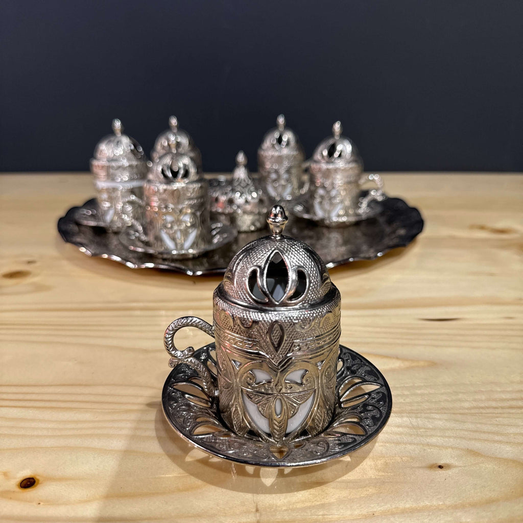 Silver Ottoman-Style Coffee Set beautifully displayed with intricately detailed silver cups and matching lids.