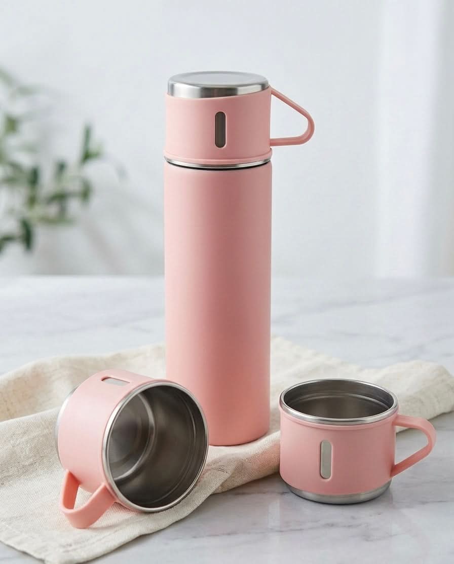 Stainless Steel Vacuum Travel Bottle with two matching cups in a soft pink color, designed for keeping beverages hot or cold.