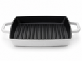 Staub cast iron grill pan 23cm with ridged cooking surface for grilling meats and vegetables.