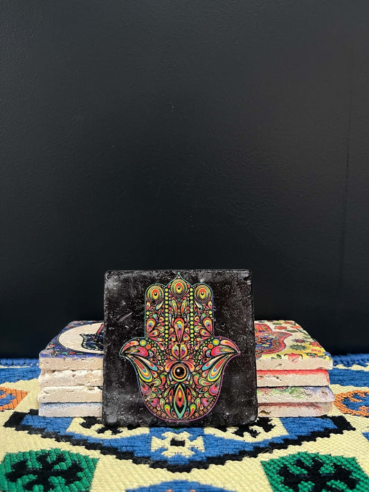 Stone Coaster Hamsa Hand Black-a captivating blend of ancient charm and artistic elegance. Crafted from genuine vintage stone, this coaster features the intricate Hamsa hand symbol, adding a touch of timeless mystique to your space. Sealed for durability,