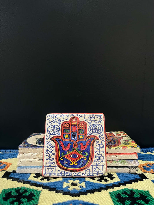 Stone Coaster Hamsa Hand White-Red-a captivating blend of ancient charm and artistic elegance. Crafted from genuine vintage stone, this coaster features the intricate Hamsa hand symbol, adding a touch of timeless mystique to your space. Sealed for durabil