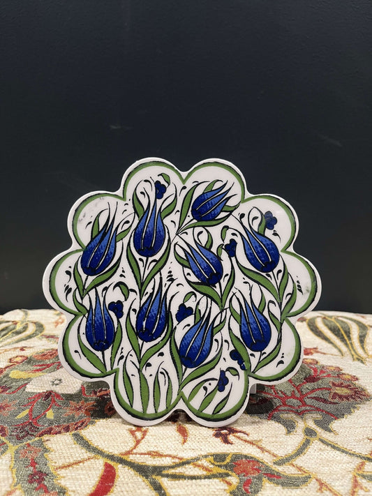 Turkish Ceramic Trivet Blue Tulip-Discover our Turkish Ceramic Trivet, a perfect blend of artistry and functionality. Crafted in Turkey, this 18cm heat-resistant trivet protects surfaces and features a vibrant mosaic design inspired by Turkish art. Easy t