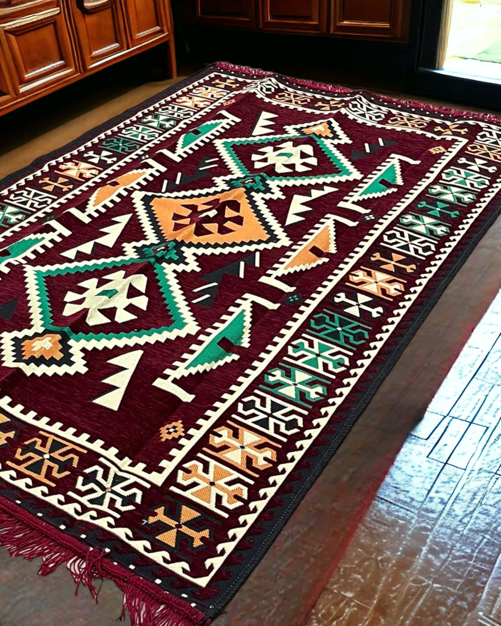 Turkish Kilim Rug – Maroon Serenity with geometric pattern on a wooden floor.