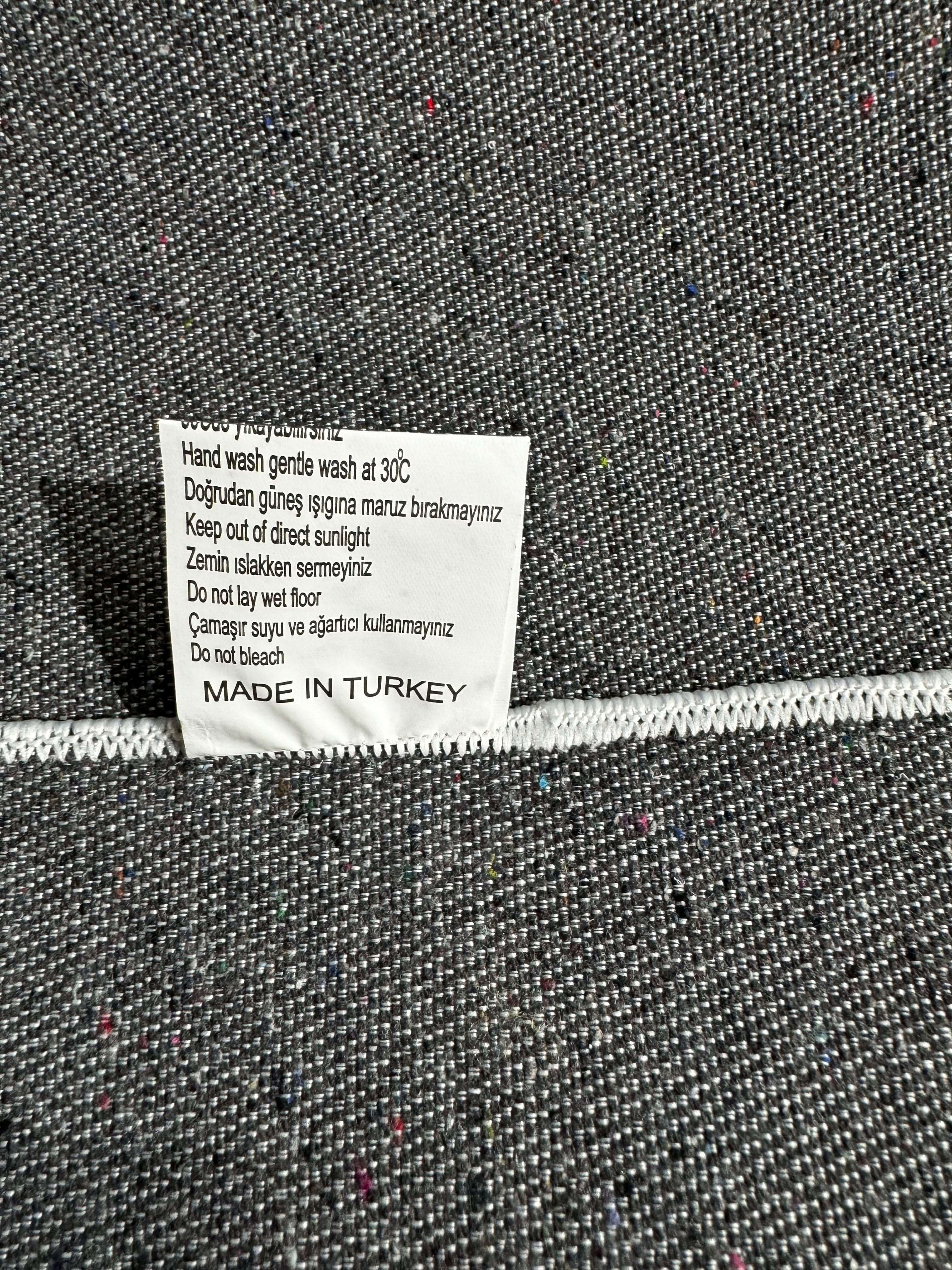 Care label on Turkish Rug listing washing instructions and Made in Turkey origin.