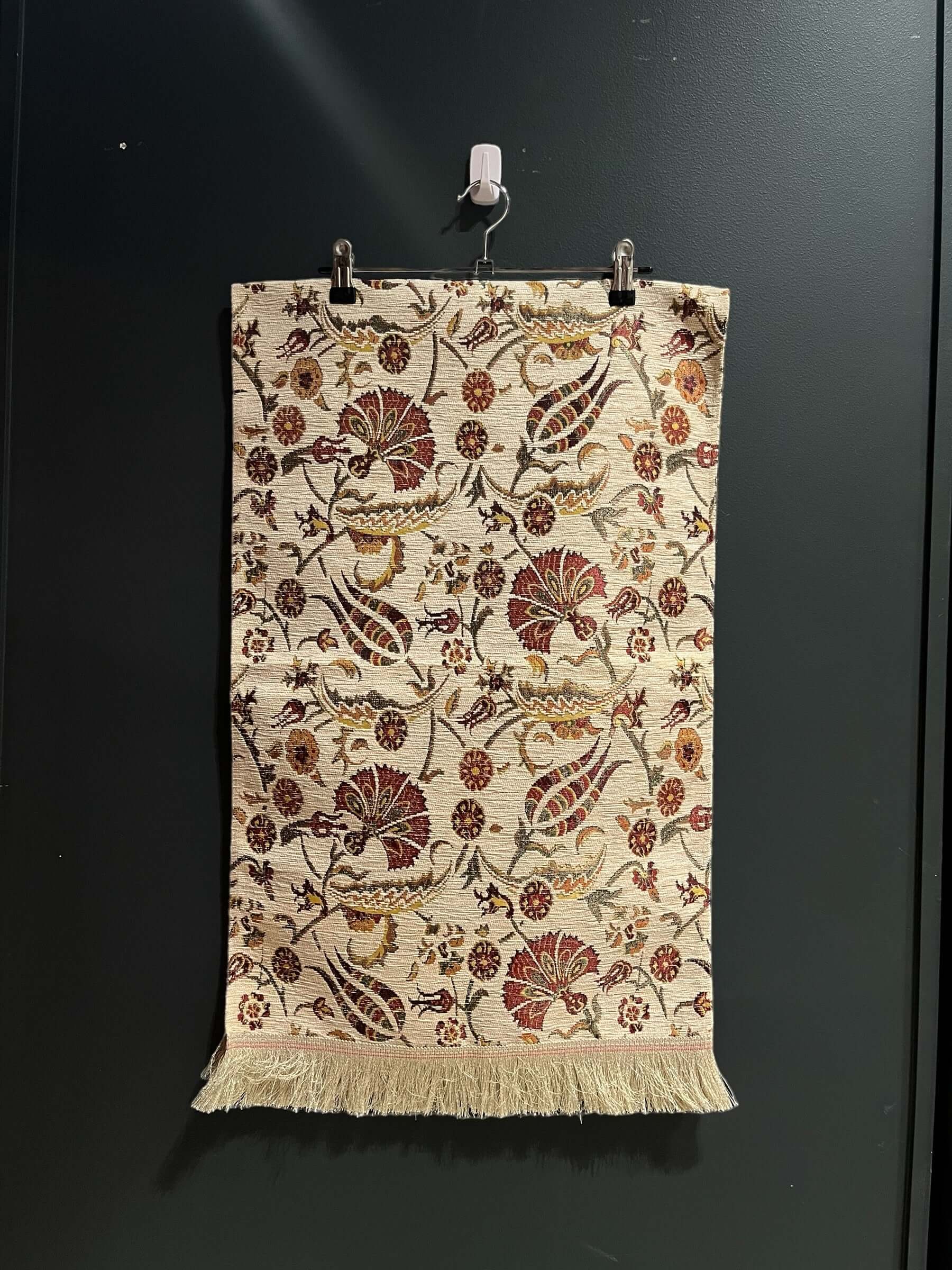 Turkish Table Runner Flowers White-Crafted from acrylic featuring a captivating blend of Tulip and Aztec designs, this table runner effortlessly adds a touch of cultural richness to any setting. Versatile and elegant, it's perfect for both casual and form