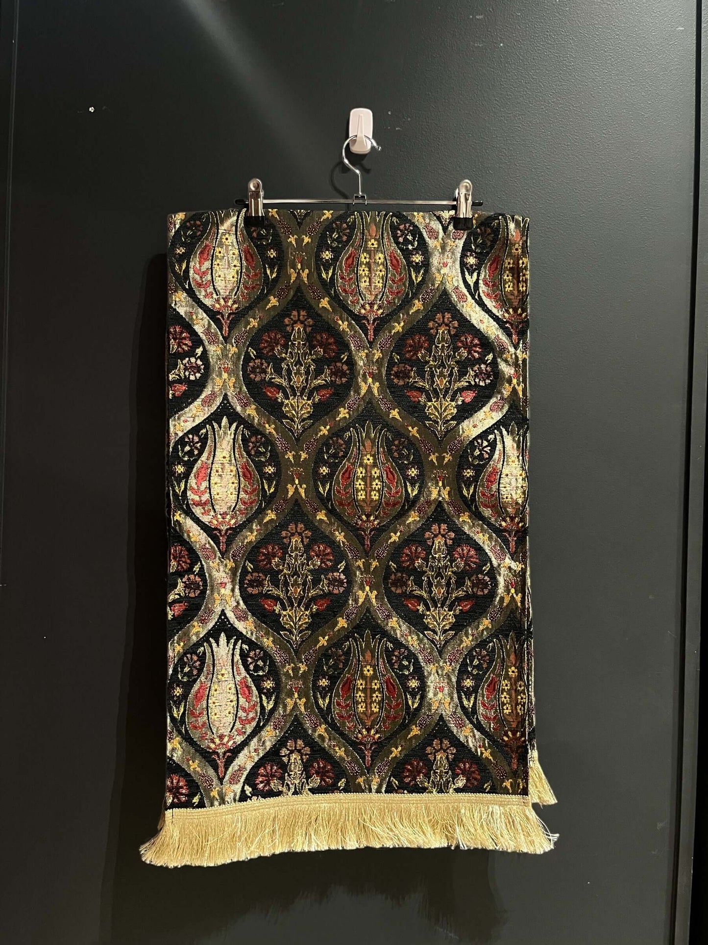 Turkish Table Runner Tulip Black-Crafted from acrylic featuring a captivating blend of Tulip and Aztec designs, this table runner effortlessly adds a touch of cultural richness to any setting. Versatile and elegant, it's perfect for both casual and formal