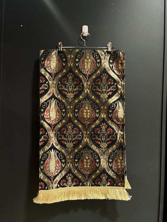 Turkish Table Runner Tulip Black-Crafted from acrylic featuring a captivating blend of Tulip and Aztec designs, this table runner effortlessly adds a touch of cultural richness to any setting. Versatile and elegant, it's perfect for both casual and formal