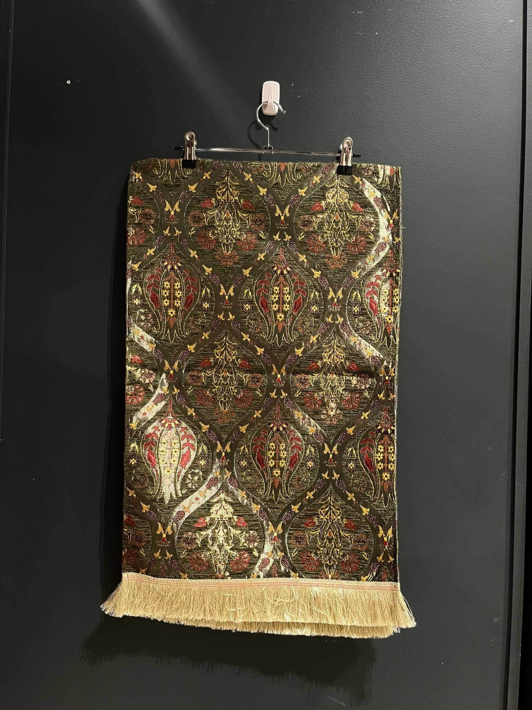 Turkish Table Runner Tulip Green-Crafted from acrylic featuring a captivating blend of Tulip and Aztec designs, this table runner effortlessly adds a touch of cultural richness to any setting. Versatile and elegant, it's perfect for both casual and formal