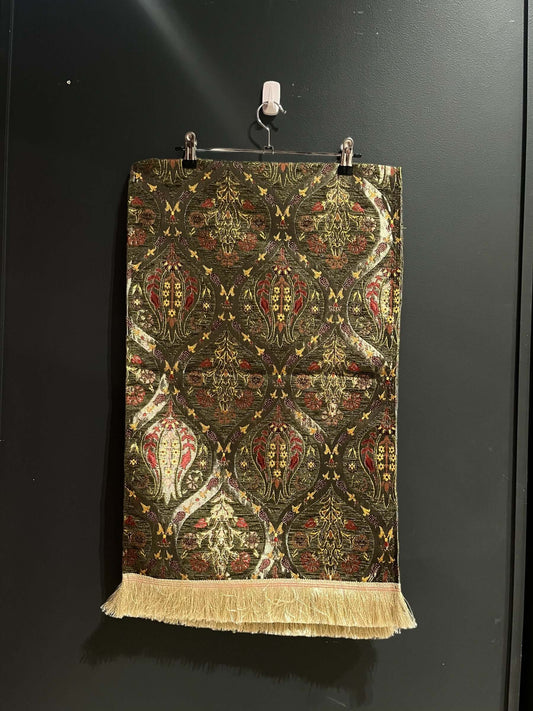 Turkish Table Runner Tulip Green-Crafted from acrylic featuring a captivating blend of Tulip and Aztec designs, this table runner effortlessly adds a touch of cultural richness to any setting. Versatile and elegant, it's perfect for both casual and formal