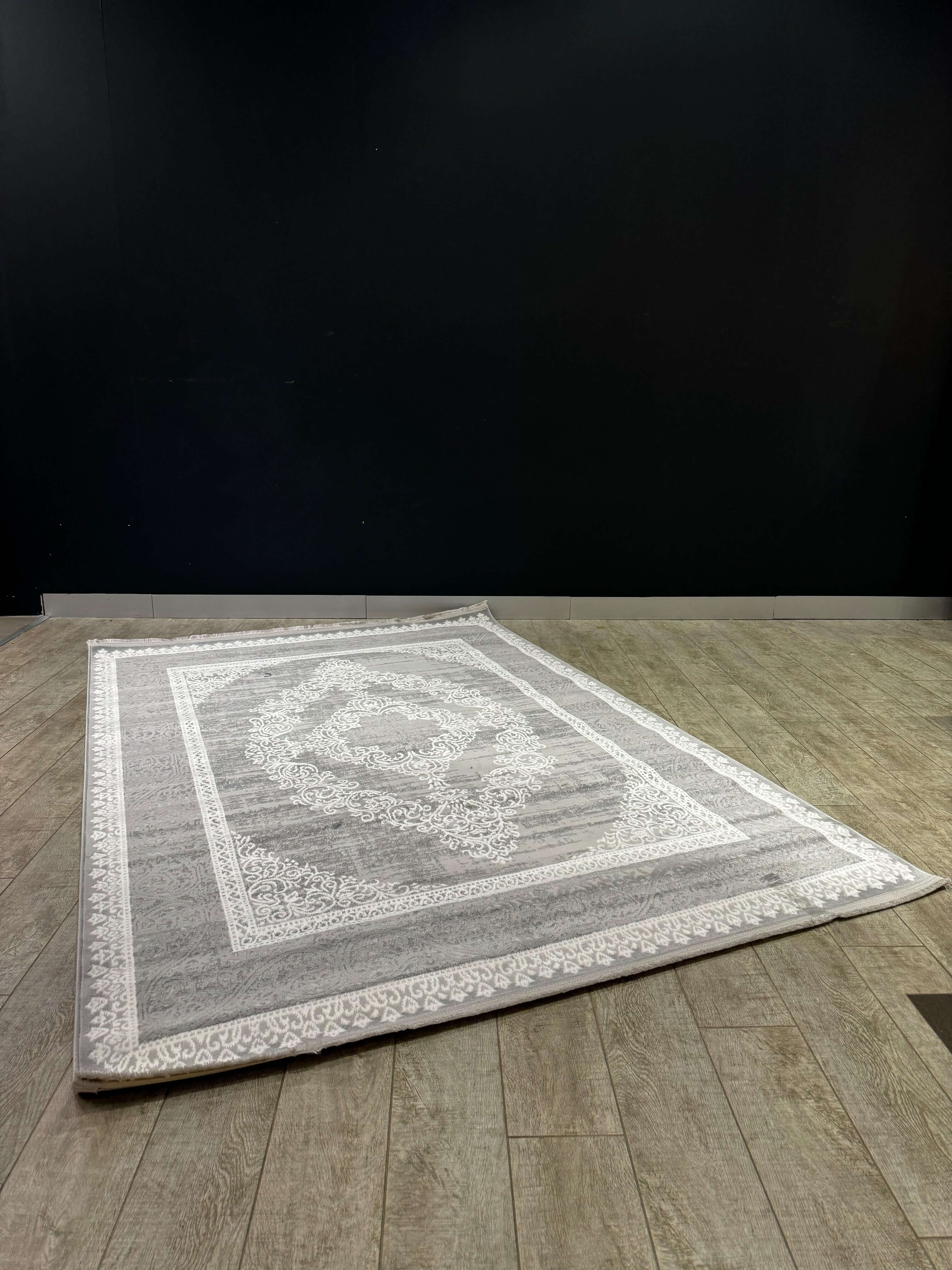 Vintage Harmony Turkish Rug displayed elegantly in a modern room with dark walls and wooden floors.