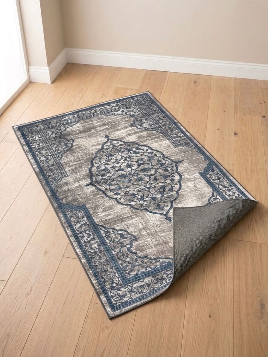Vintage Medallion Prayer Mat showcasing a blue and beige design on a wooden floor, perfect for meditation and reflection.