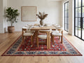Anatolian Heritage 240 × 330 cm red and blue Turkish rug beneath a timber dining table in an open-plan dining room