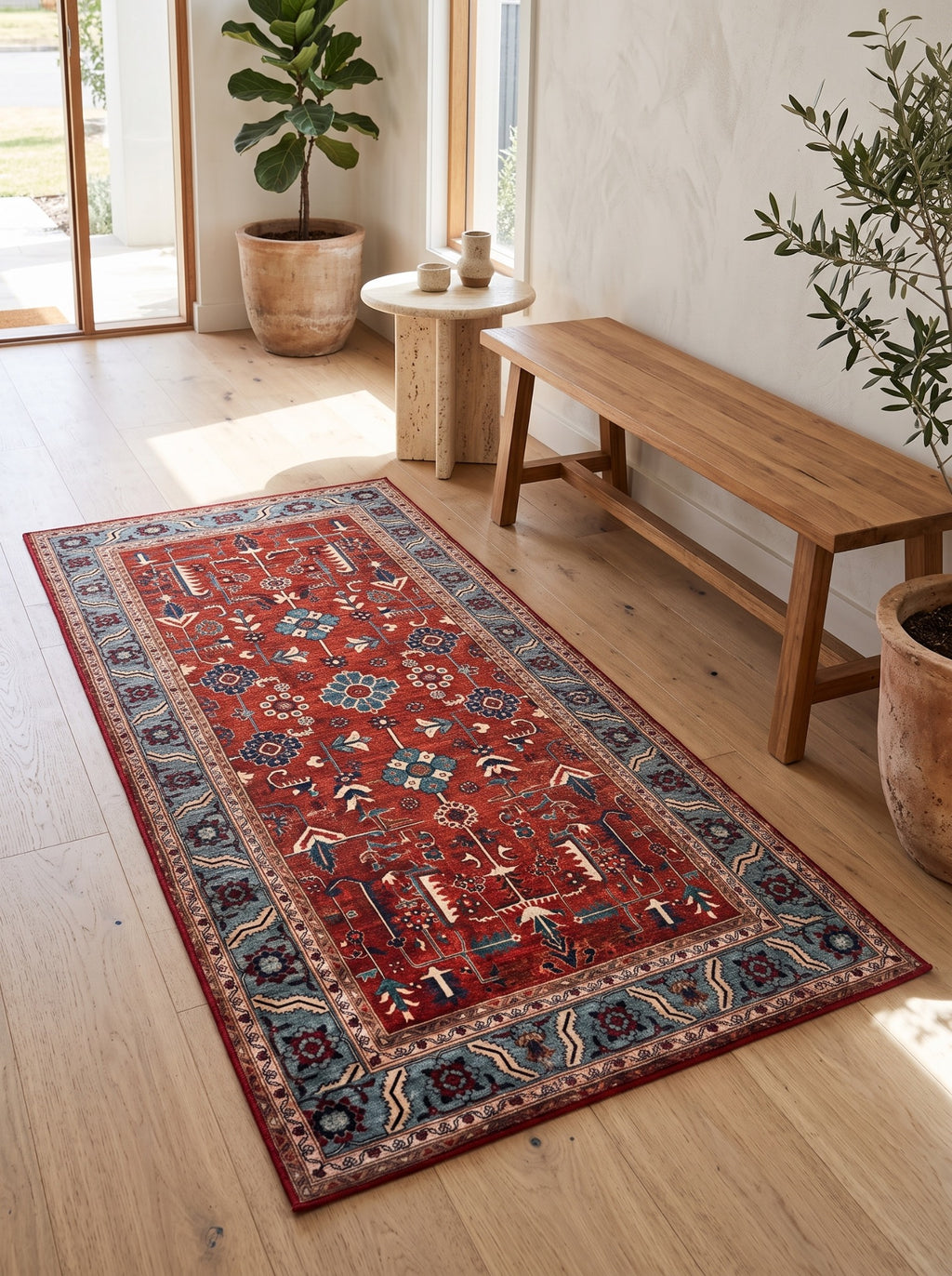 Anatolian Heritage red and blue Turkish rug beside a timber bench in a sunlit entryway