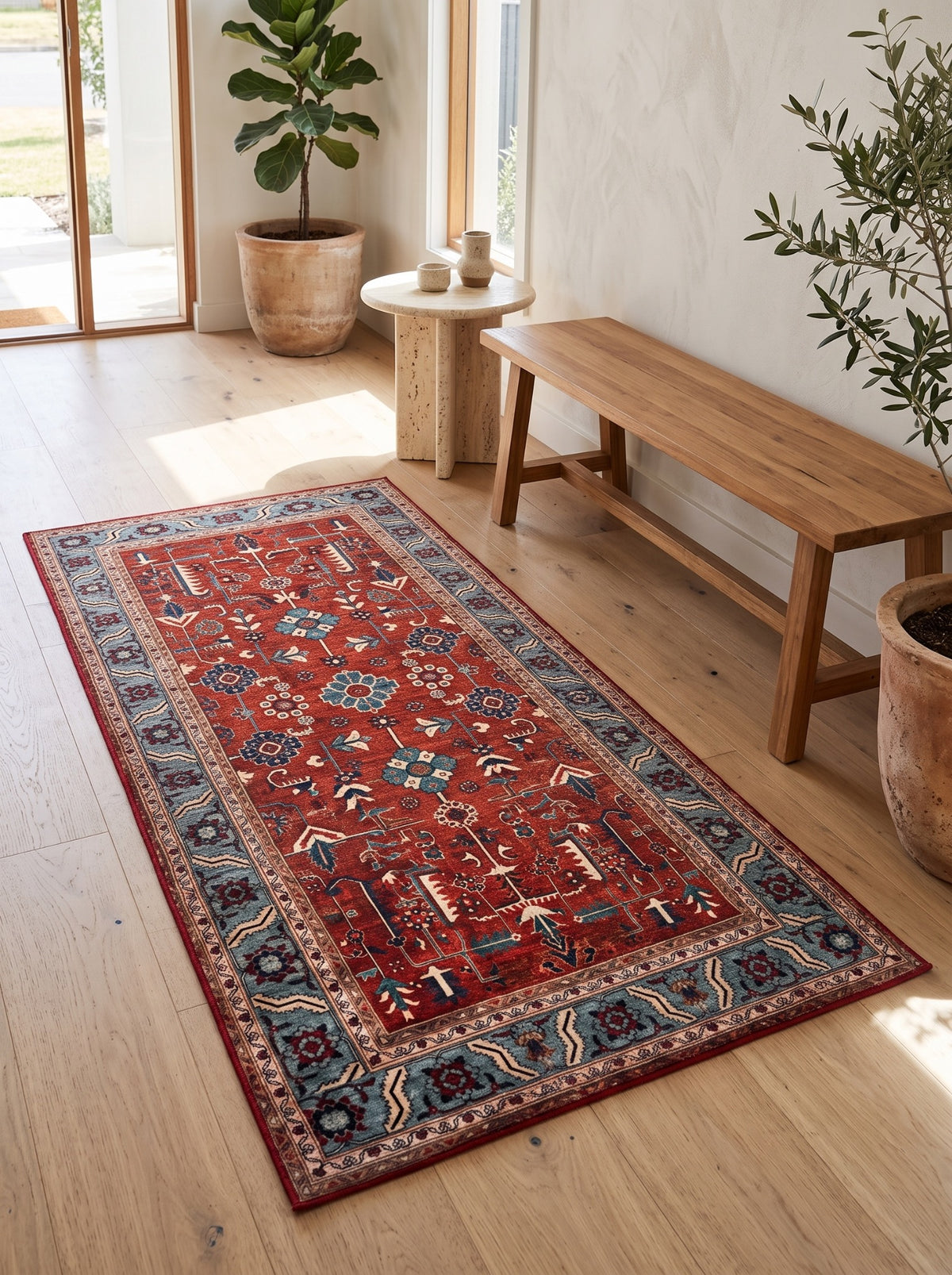 Anatolian Heritage red and blue Turkish rug beside a timber bench in a sunlit entryway