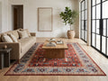 Anatolian Heritage red and blue Turkish rug styled beneath an oak coffee table in a neutral living room