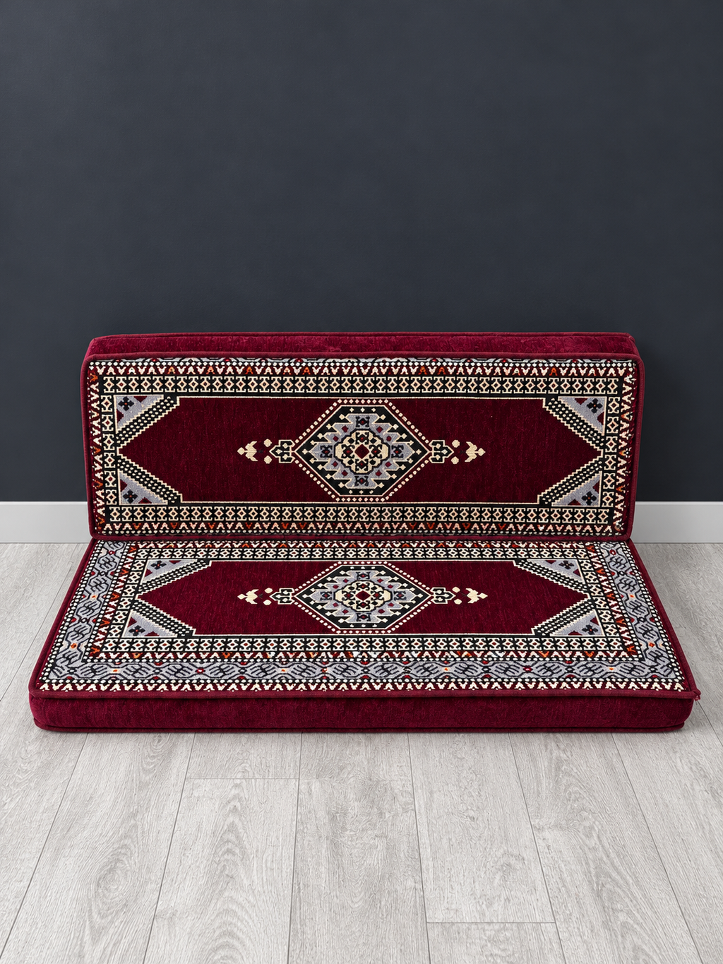 Maroon Palace double seater Arabic Majlis floor sofa against a charcoal wall