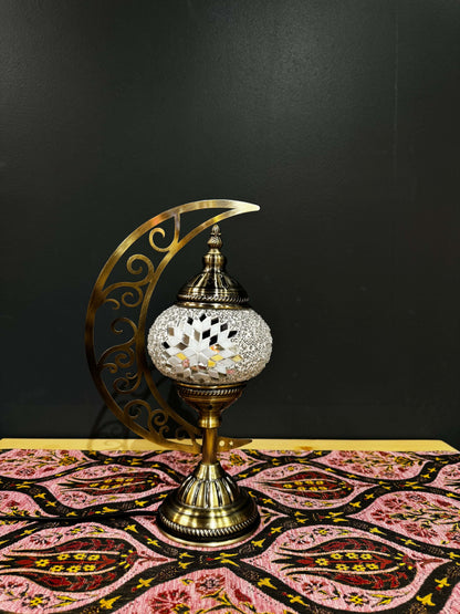 Midnight Glow Turkish Mosaic Lamp on crescent moon stand, featuring black, white, and red mosaic design.