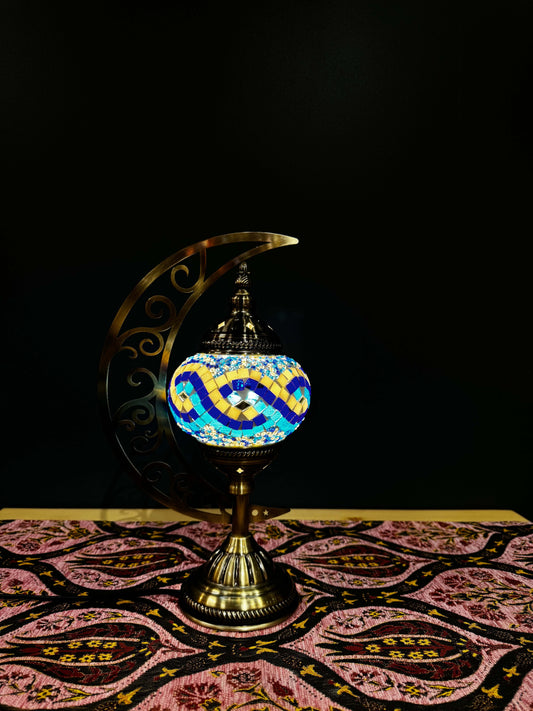 Sunrise Wave Turkish Mosaic Lamp - Crescent Moon DesignShop the Sunrise Wave Turkish Mosaic Lamp! Features vibrant yellow, blue, and turquoise wave mosaic design with a crescent moon stand. Includes LED bulb.