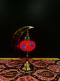 Crimson Bloom Turkish mosaic lamp with red floral design on crescent moon stand, perfect for home decor.