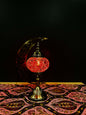 Crimson Glow Turkish Mosaic Lamp with crescent moon stand on decorated table, emitting warm red light. Perfect for elegant decor.