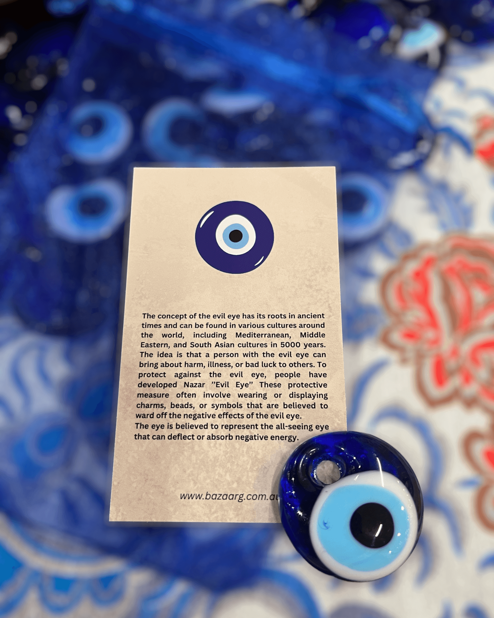 Evil Eye Bead (Nazar) displayed with informational card about its protection symbolism.